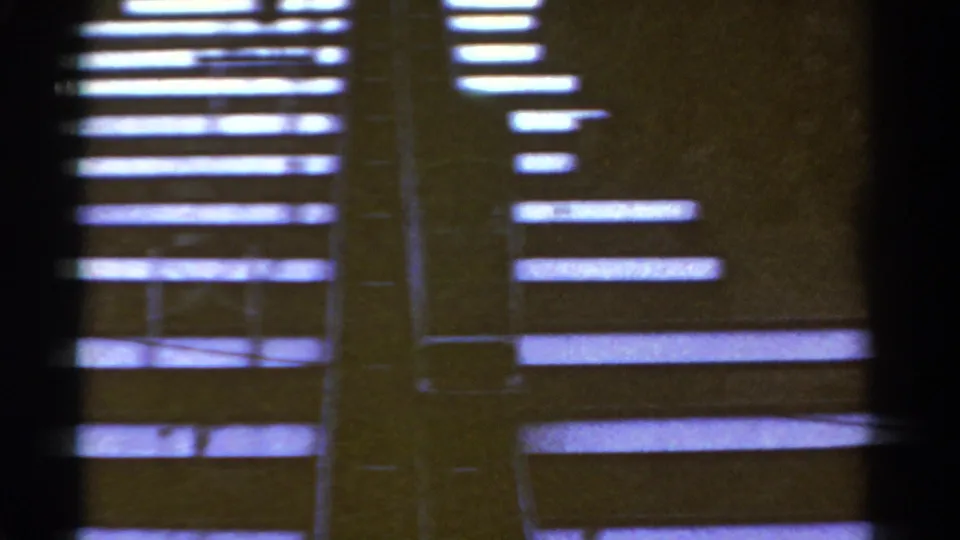 1967 Colorado 8mm frame showing an abstracted view of wooden stair shapes, dark film borders, and uneven exposure.