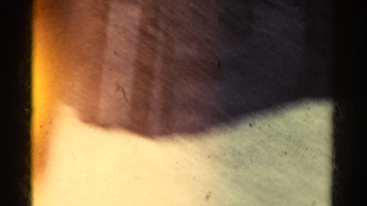 1967 8mm Colorado bus footage begins with a dark interior edge, bright window light, and a soft view of dry hillside outside.