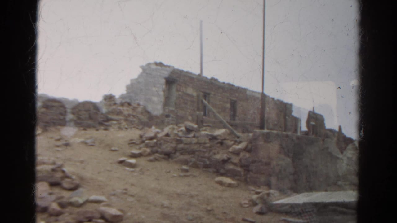 Weathered stone walls and scattered rocks appear in a 1967 Colorado travel shot on faded 8mm film.