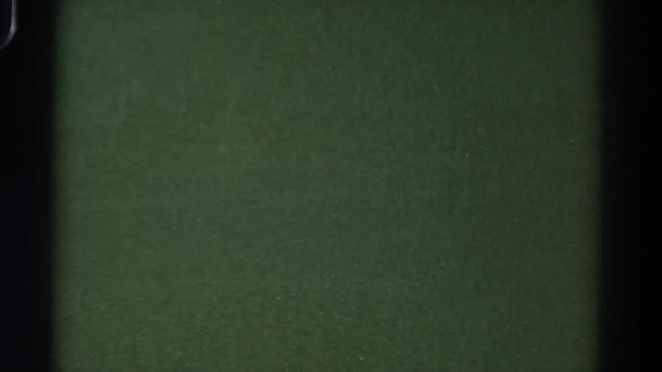 1967 Colorado 8mm frame showing a dim murky underwater view with green-brown texture and dark film edges.