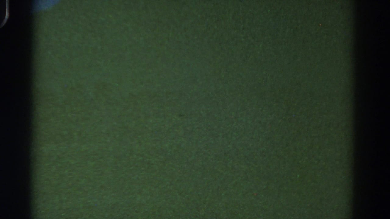 1967 Colorado 8mm frame with murky green water, faint particulate texture and a dark vertical film edge.