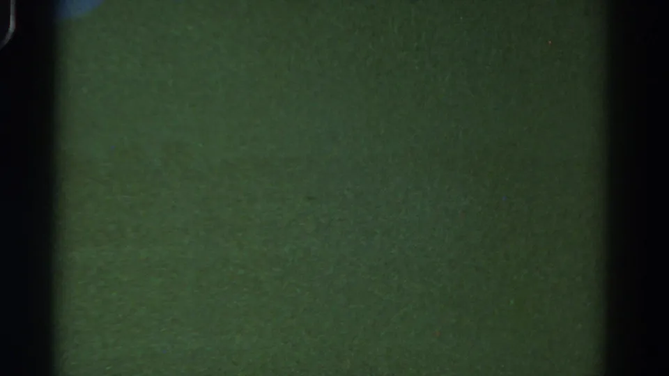 1967 Colorado 8mm frame with murky green water, faint particulate texture and a dark vertical film edge.