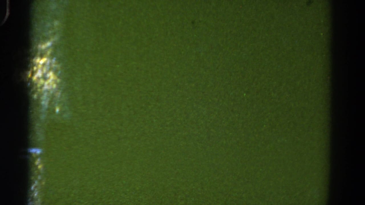 1967 Colorado road-view frame with green blur, film texture, and a dark car-window divider.