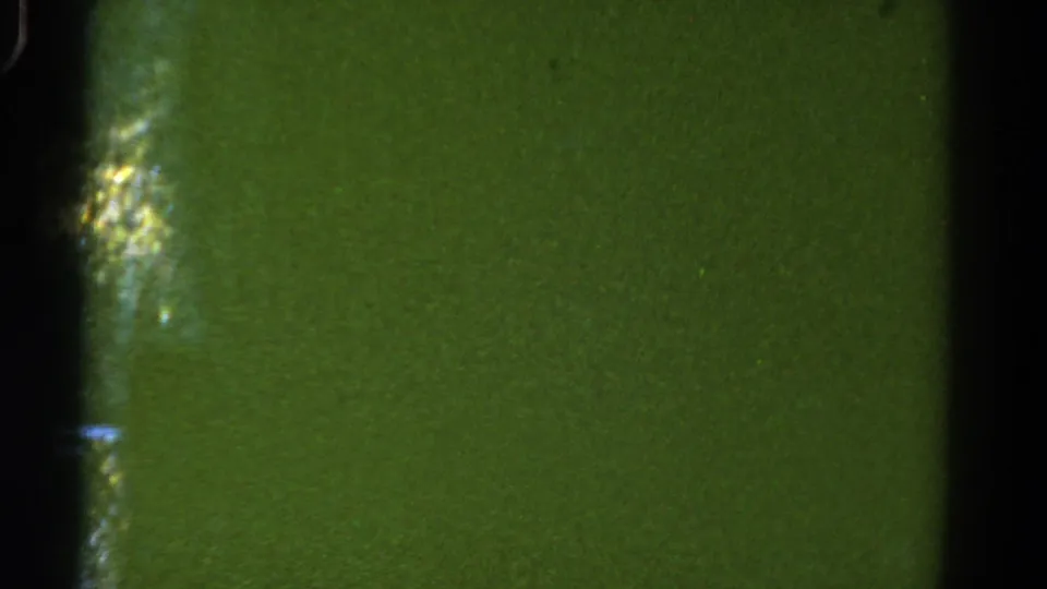 1967 Colorado road-view frame with green blur, film texture, and a dark car-window divider.