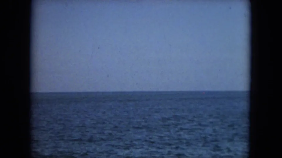 Open Florida coastal water fills the frame, with a low horizon and soft 8mm color from the 1967 home-movie scan.