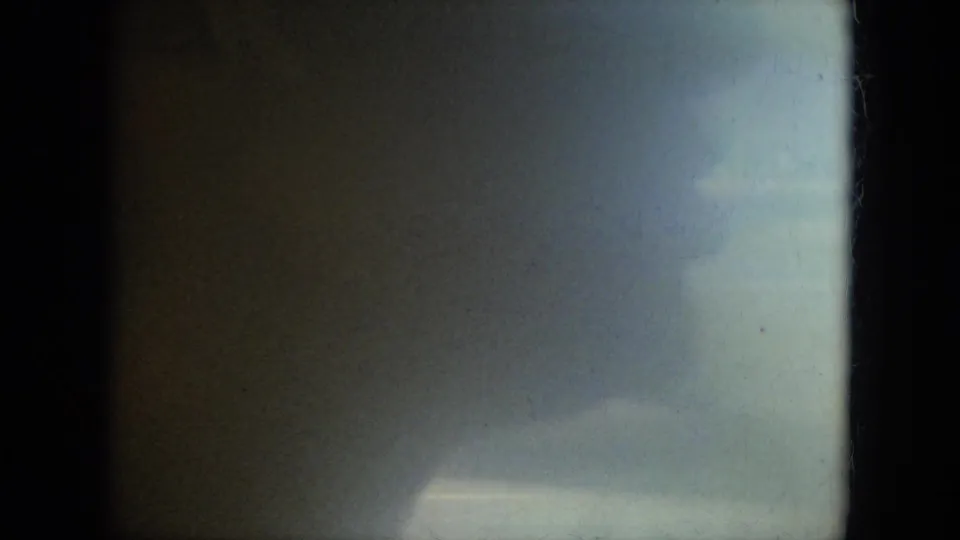 1967 Florida 8mm frame with heavy grain, soft focus, dark borders, and an indistinct green-yellow exposure shift.