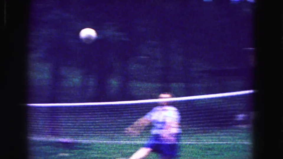 A light-colored volleyball moves over the net during a backyard game in the 1967 Galena, Illinois home movie.