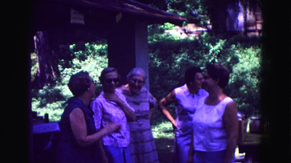 A candid 1967 Galena porch scene shows adult women chatting in a loose group near outdoor gathering items.