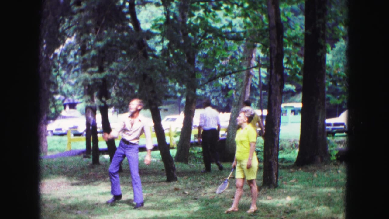 The 1967 Galena park scene shows a man and woman with badminton rackets under trees, with a background pedestrian and parked cars visible.