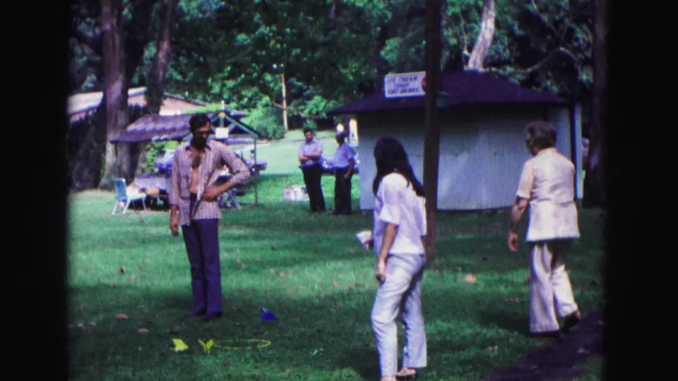 The Galena home movie shows adults crossing and watching a grassy park activity area during a 1967 outdoor event.