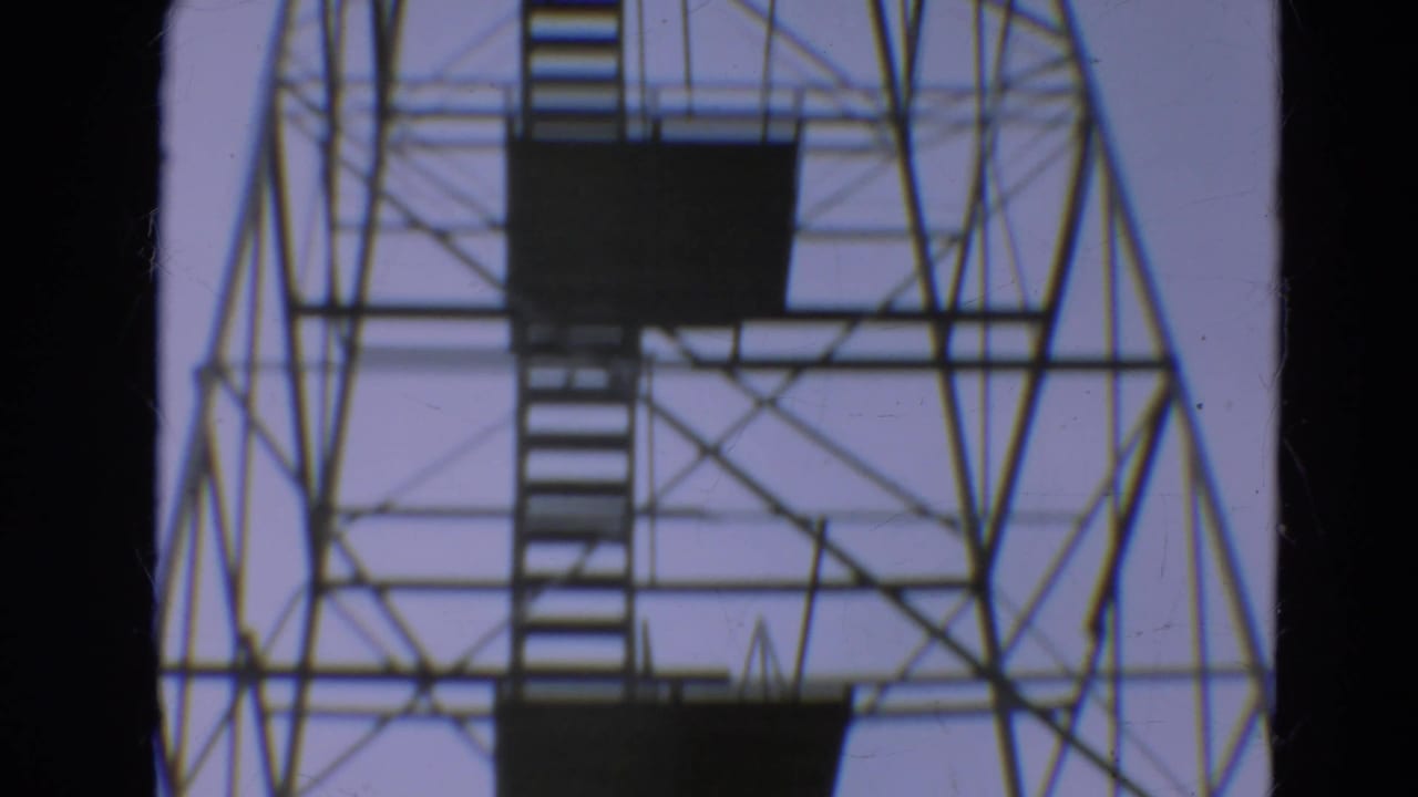 1967 Minnesota 8mm view of the tower's upper lattice, stacked stairs, and dark viewing platforms.