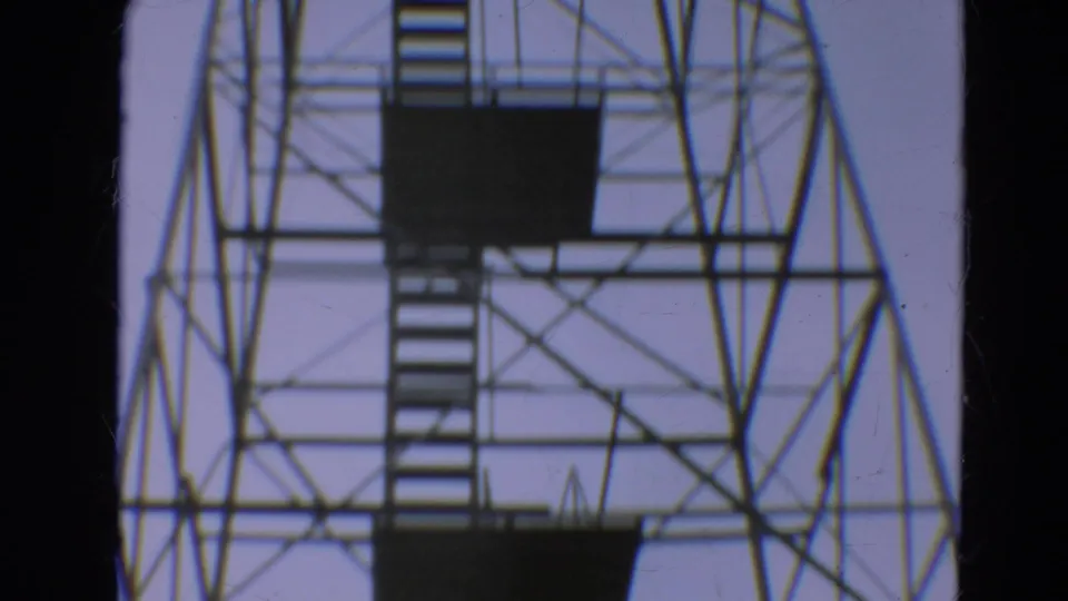 1967 Minnesota 8mm view of the tower's upper lattice, stacked stairs, and dark viewing platforms.