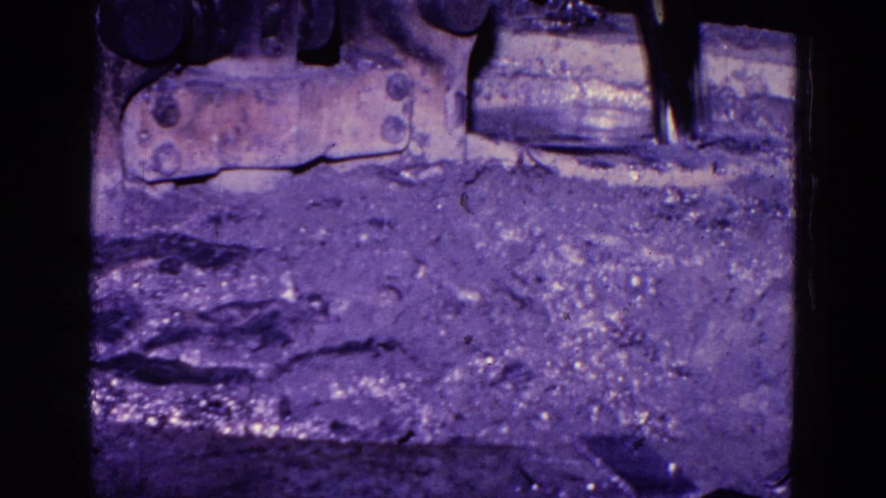 Similar close view of floor material and metal equipment beside dark frame edges.