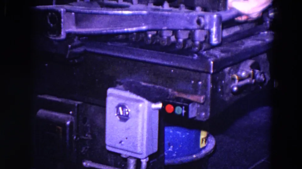 1967 Trenton 8mm close-up of a heavy industrial machine, showing riveted metal, a control box, and red and green indicator lights.