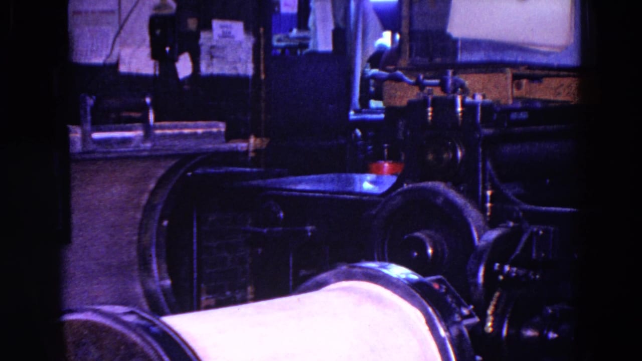 Workshop machinery and a metal table seen from a similar dim angle.