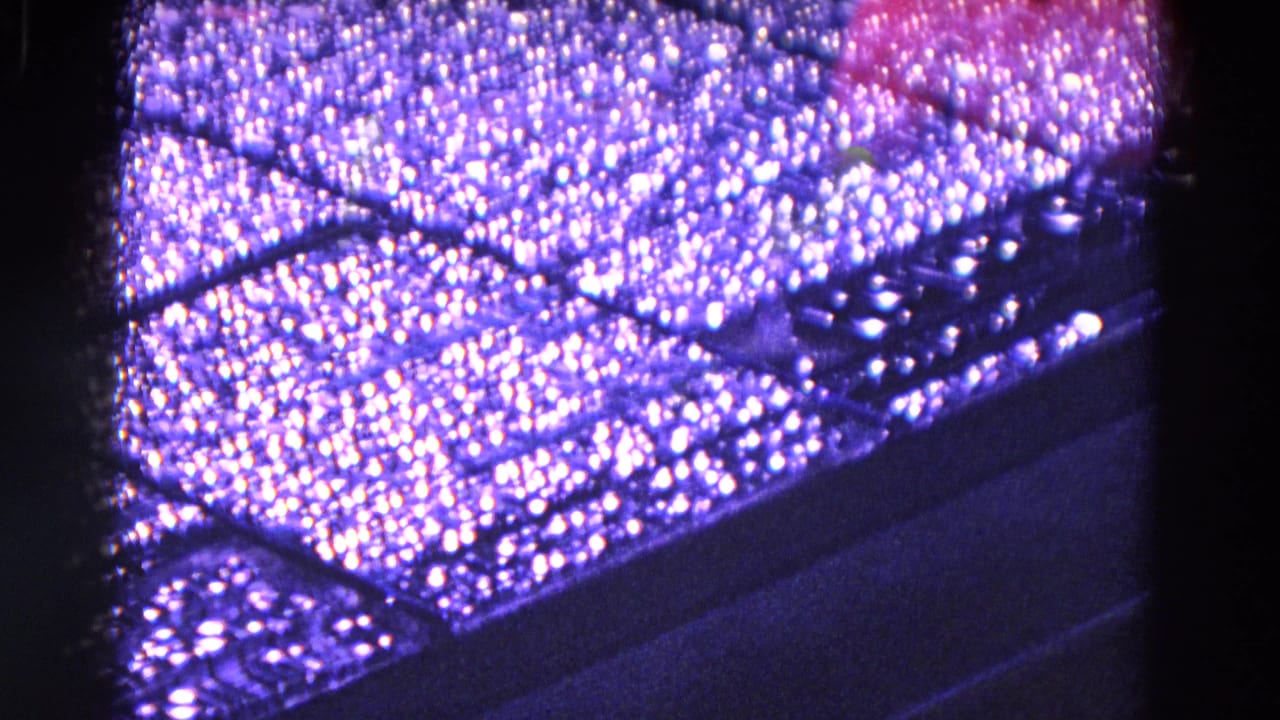 Close-up of a dark textured machine surface with bright speckled reflections.