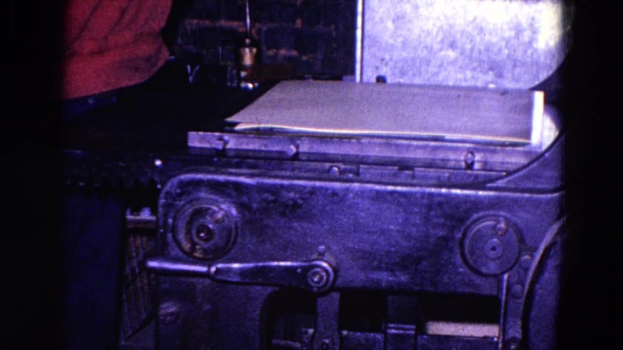 1967 Trenton factory footage showing a red-shirted worker partly visible beside a heavy industrial press and flat material.
