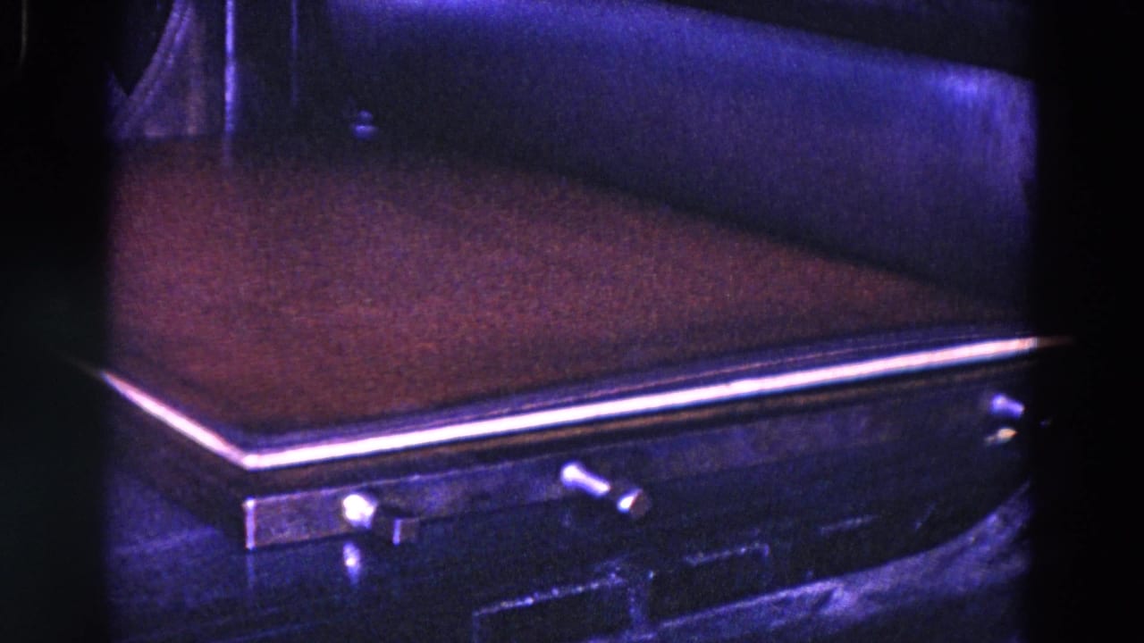 A close 8mm view shows the press bed, flattened material, metal trim, and small controls in the factory setting.