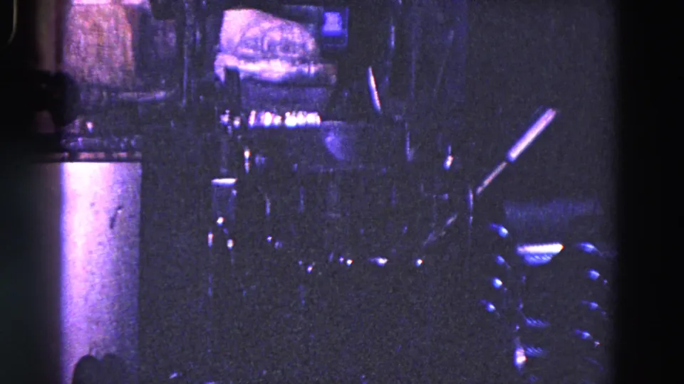 Final frame of the 1967 Trenton machine sequence, showing dark phosphating equipment, vertical posts, and a small horizontal cylindrical part.