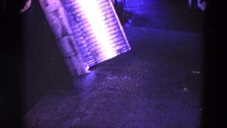 1967 Trenton frame showing the corrugated metal tube angled over a dark work surface, with bright reflection and possible metal dust below.