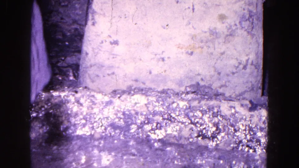 The final frame shows the lower portion of the interior, with the wall, floor, dark frame edge, and a partial figure near the side.