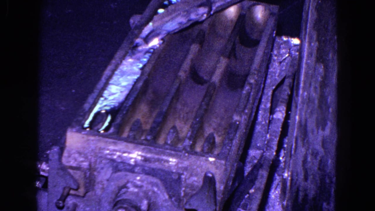 Molten metal and thick casting molds in a dark industrial setting.
