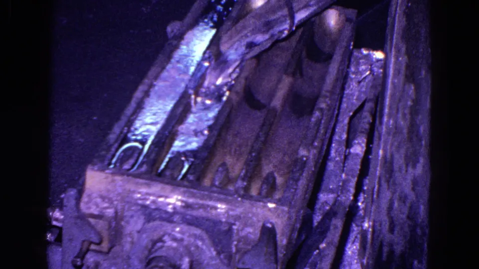 1967 8mm frame from a Trenton ironworks showing a thick mold from above with molten metal and strong blue-purple exposure.