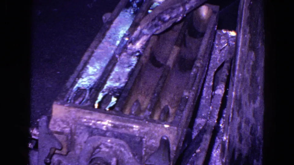 1967 8mm frame from Trenton showing a close, angled view of a metal mold or casting surface with strong purple-blue film color shift.