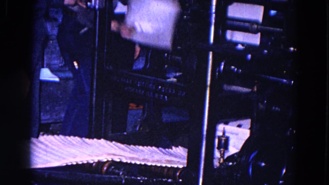 A worker moves beside the press while newspapers lie across the foreground in this 1967 Trenton print-room scene.