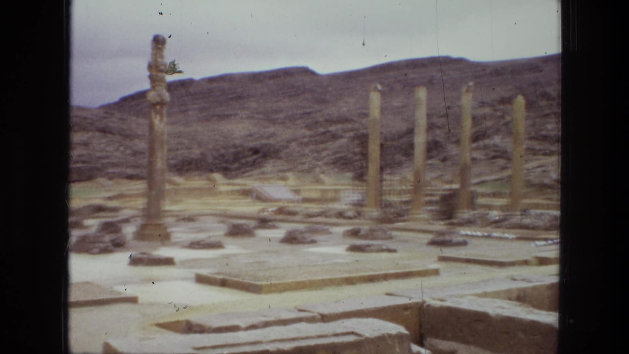 1972 Iran 8mm frame with multiple standing columns, broken masonry, low platforms, and dry hills behind the site.