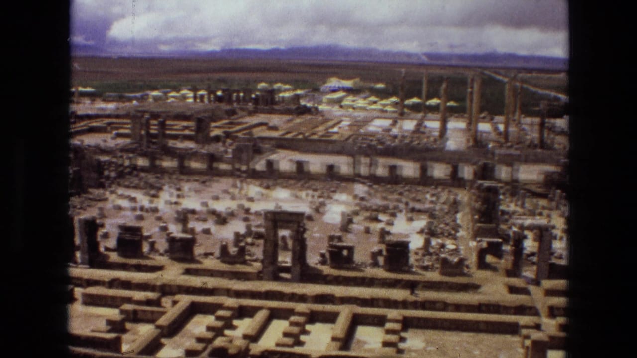 Aerial 1972 Iran footage, likely over Persepolis, with columns, carved stone remains, tents, and vehicles near the site.