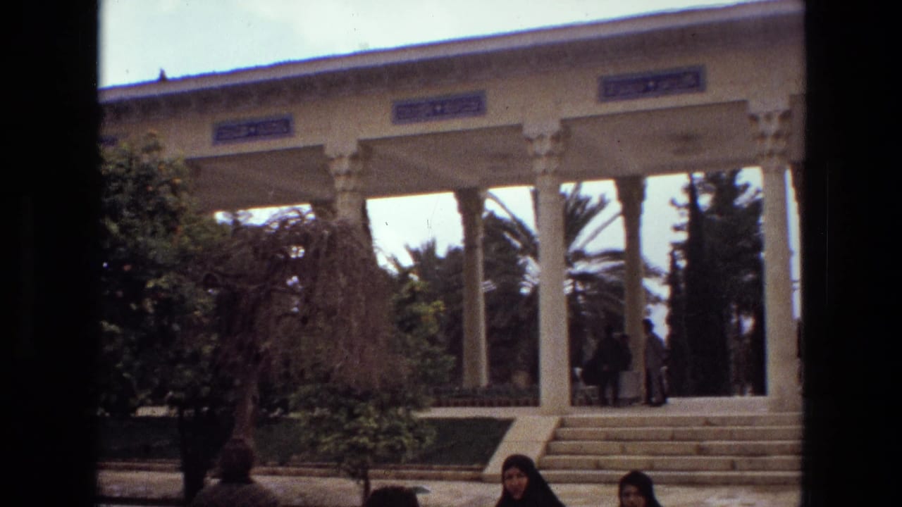 Colonnaded garden structure behind trees with people near the steps.