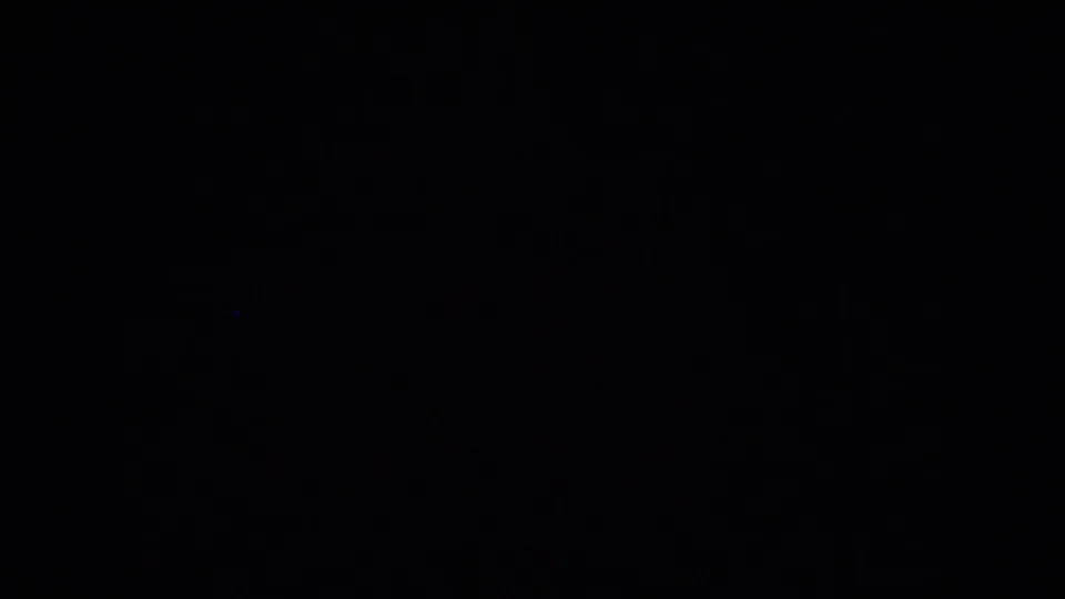 Mostly dark 8mm frame with no clear subject visible, likely an intermittent black or underexposed section of the clip.