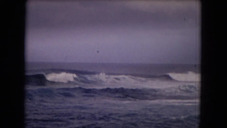 1968 Hawaii home-movie view of choppy surf and low breaking waves, softened by aged 8mm color and focus.