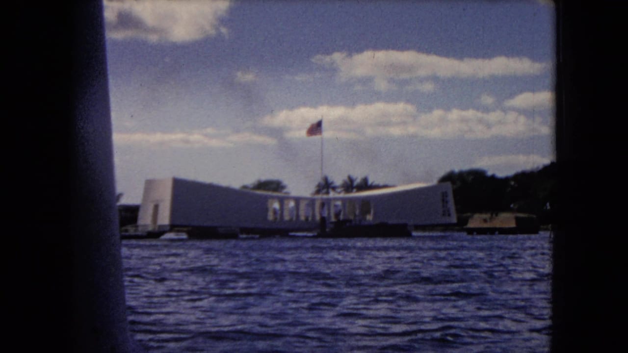 1968 Honolulu home-movie view from a boat approaching the USS Arizona Memorial across Pearl Harbor water.