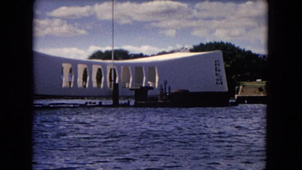 Closer 1968 boat-level view of the USS Arizona Memorial, showing its openings, dock structures, and harbor water.