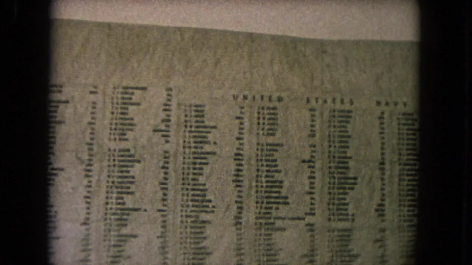 A visitor-shot 8mm view of the U.S.S. Arizona Memorial name wall in Honolulu, with Navy names visible in columns.