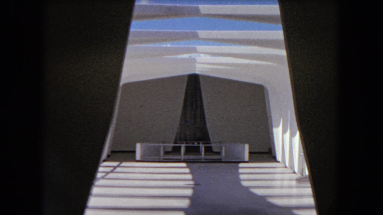 1968 Honolulu home-movie frame showing a white boat interior or deck structure crossed by sunlight and shadow.