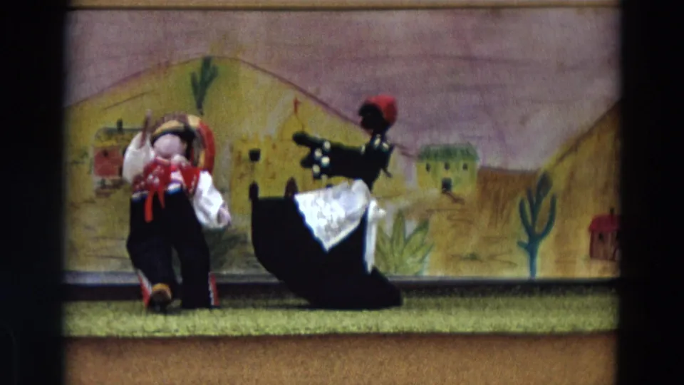 The female puppet doll dips or turns beside the male doll as the 1968 Lahaina stage presentation nears its end.