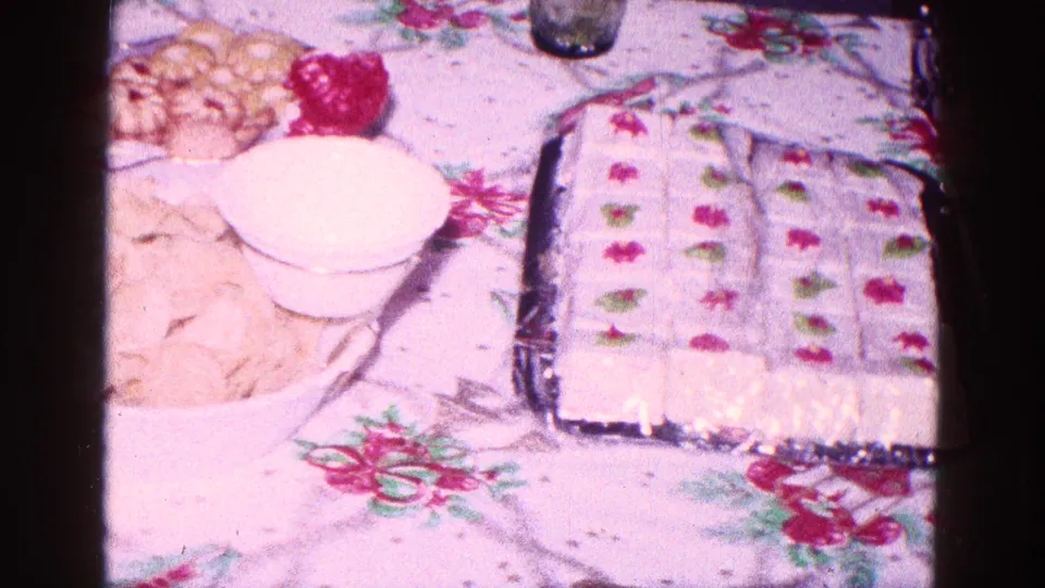 1968 Minnesota holiday table frame showing chips, cookies, a white bowl, and a tray of frosted dessert squares.