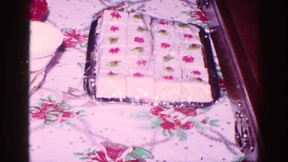 Decorated party cake on a tray, filmed close up in a 1968 Minnesota private home interior.