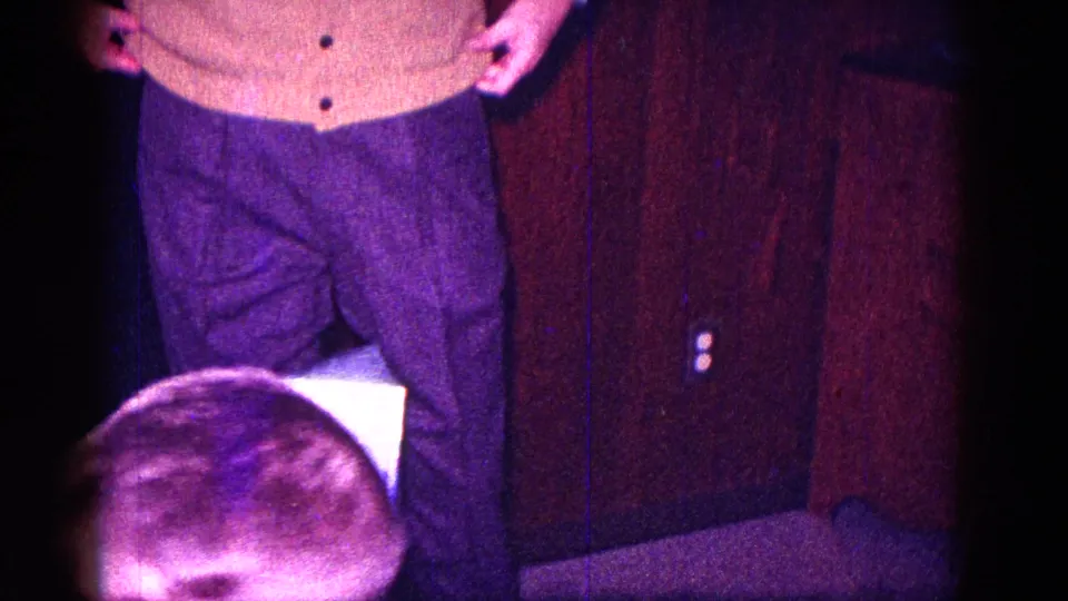 At the end of the brief gag, the man stands over the partly crushed box area in a dim wood-paneled 1968 Minnesota home interior.