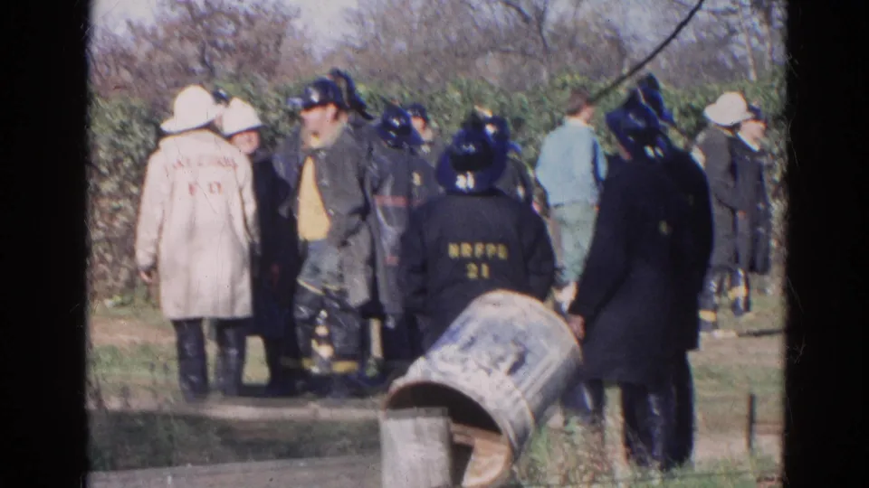 Firefighters in dark coats and helmets gather in Wauconda, Illinois, with Lake Zurich F.D. and NRFPD markings visible.