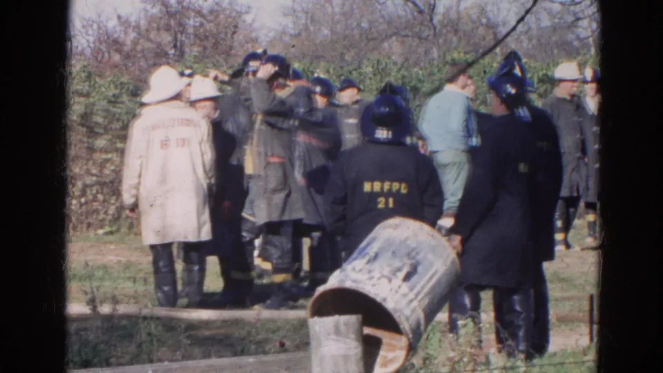 Firefighters in Wauconda, Illinois stand together outdoors, with department lettering visible on coats and helmets.