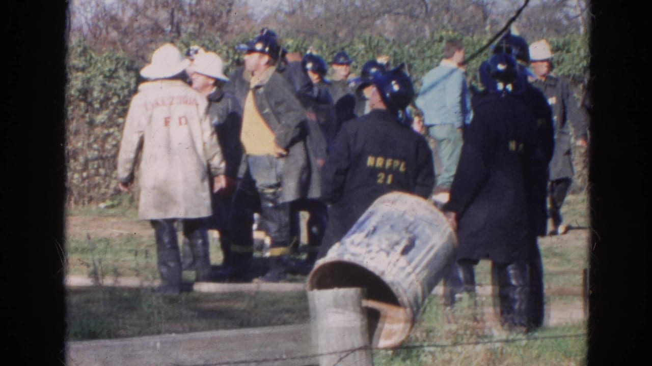 1968 Wauconda frame with firefighters and emergency personnel standing outdoors, including coats marked NRFPL 21.