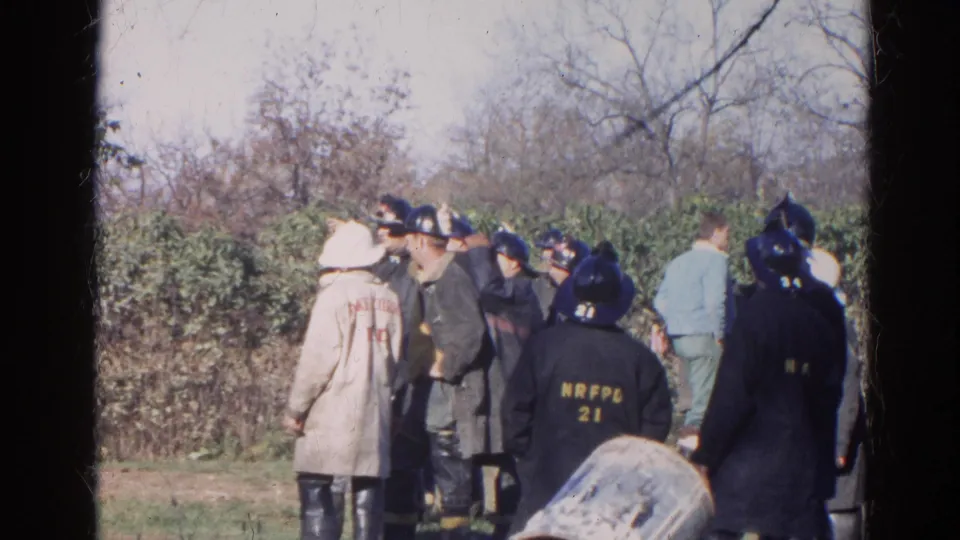 1968 Wauconda, Illinois frame showing firefighters or officers gathered outdoors, with department-style lettering visible on coats.
