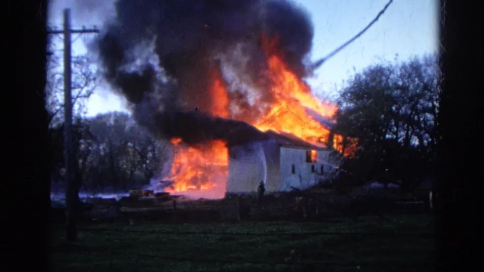 1968 Wauconda footage shows a rural building fire with a small human figure silhouetted near the structure and smoke filling the sky.