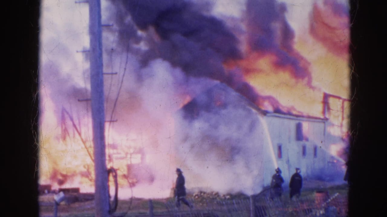 1968 Wauconda frame with thick smoke rolling over a white house as firefighters continue spraying water at the blaze.