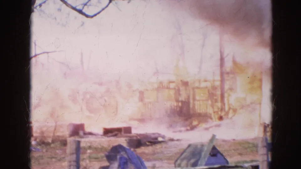 In the final frame, smoke fills the Wauconda fire scene while a charred structure and yard debris remain visible through the haze.