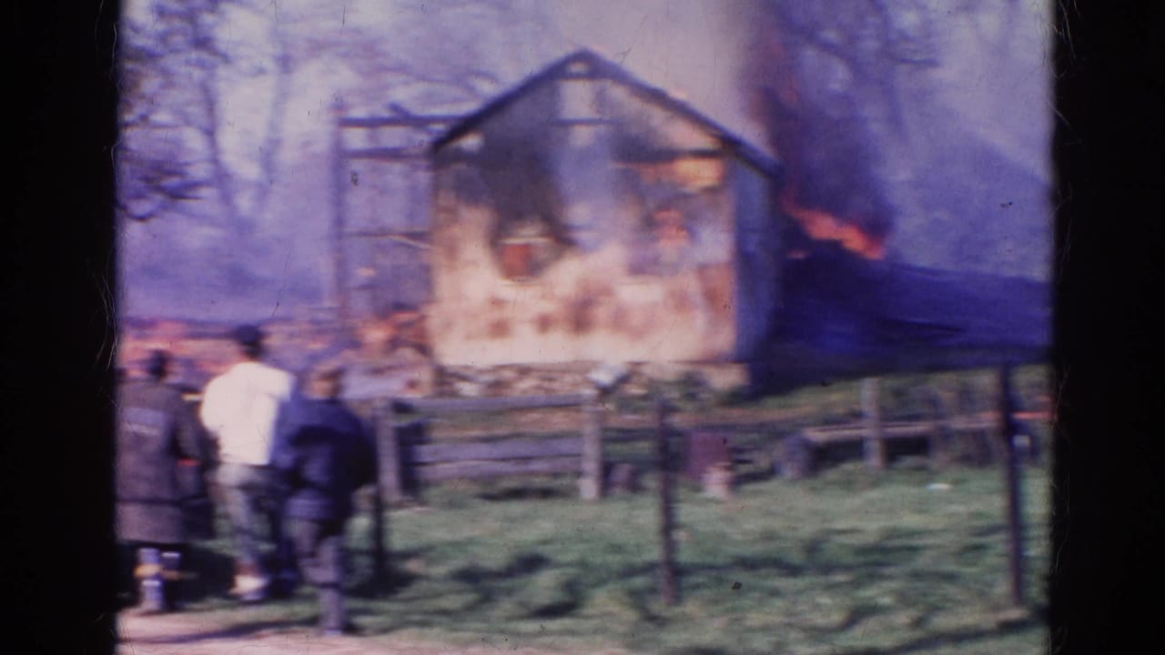 1968 Wauconda, Illinois 8mm frame with heavy smoke and flames as bystanders observe the structure fire.